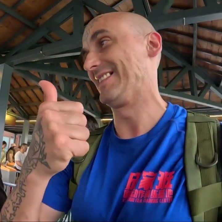 Aang Willians faz sinal de positivo na estação de entrada da Grande Muralha. 24 de julho de 2025, do canal dele no YouTube.